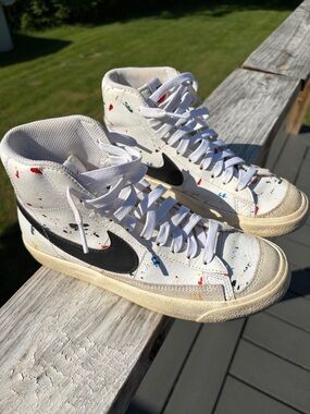 Nike White High-Top Sneakers with Black Swoosh and Paint Splatter